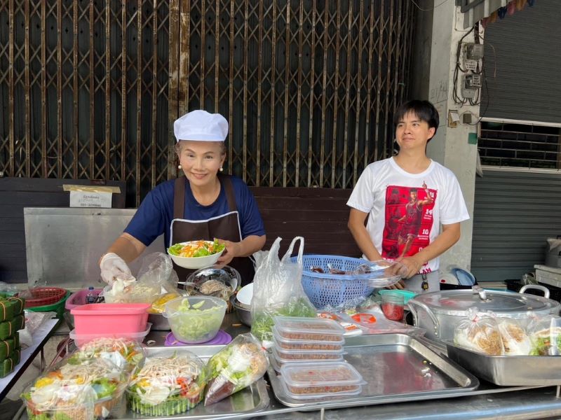 une vendeuse vend des plats vietnamiens