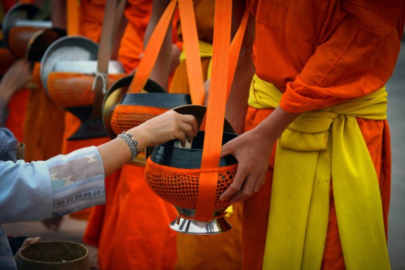  Des moines bouddhistes reçoivent respectueusement du riz et de la nourriture