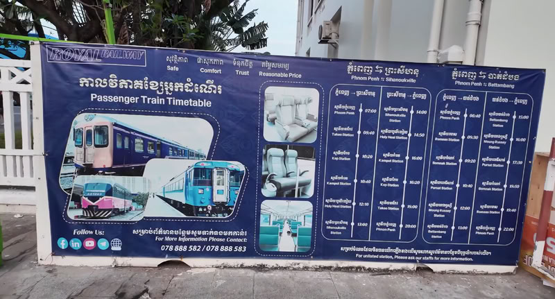 Des affiches d'information sur les deux trains sont accrochées au mur extérieur de la gare.